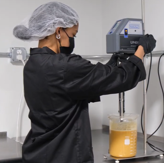 Happy Mushroom Co. Production Tech operating ultrasound assisted extraction (UAE) machine.